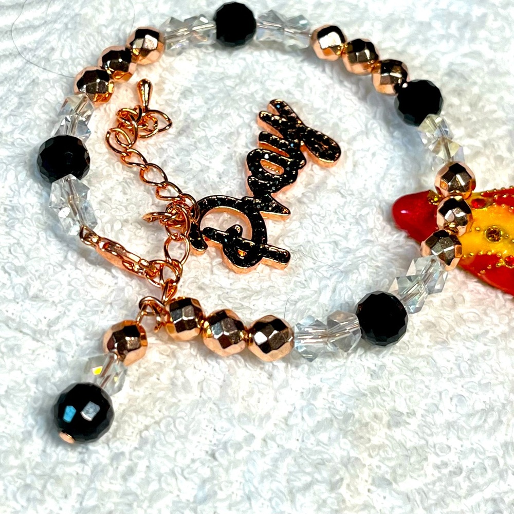 Rose gold bracelet with dangle charm that says PRAY